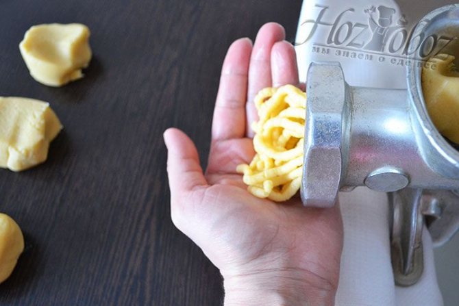 Итак, готовое тесто пропускаем через мясорубку и по мере формирования лапши надрываем или отрезаем заготовки произвольной длины, как на фото